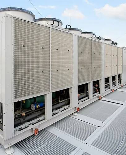 Commercial building's rooftop cooling system with multiple chiller units.