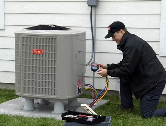 Technician servicing a Bryant energy-efficient heat pump installation.