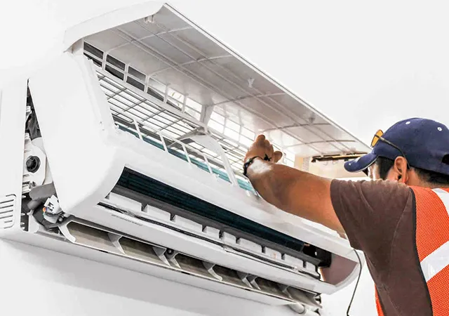 The technician is repairing the AC system.